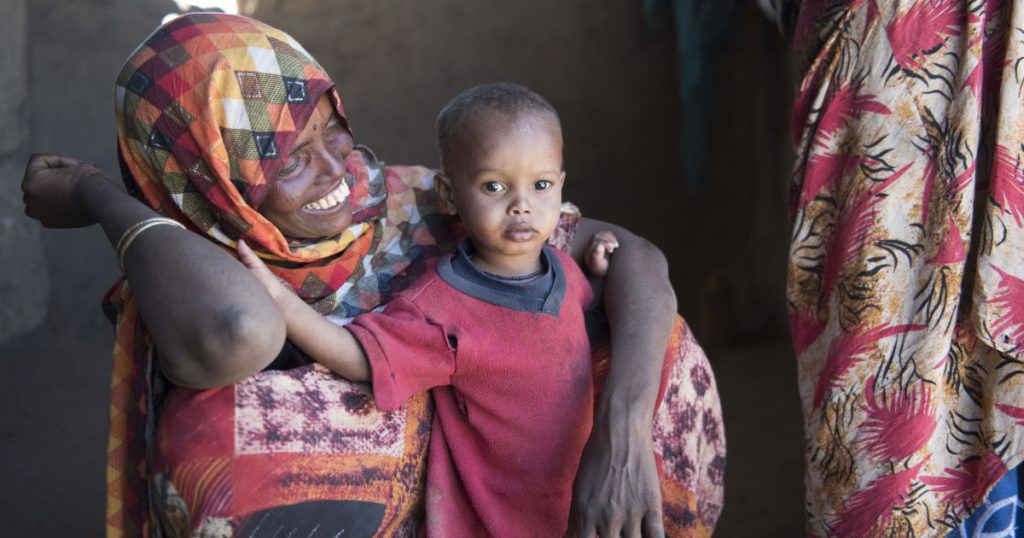 Smiling Somali mother with young child