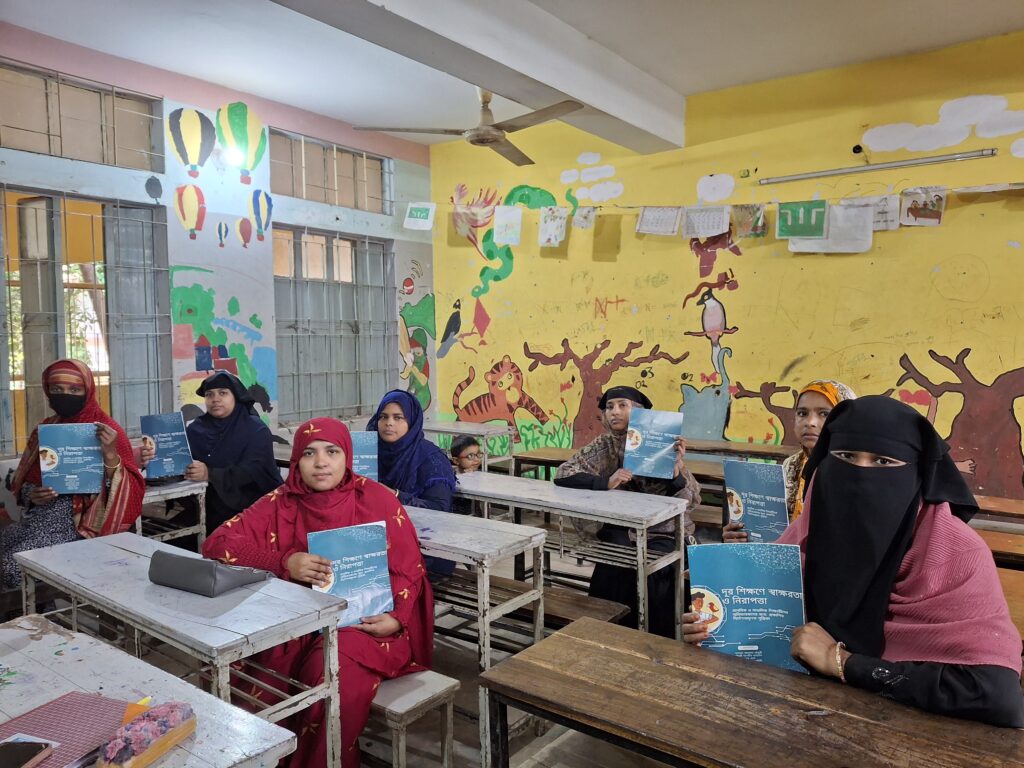 Asia Pacific women seated in a classroom showcasing educational material