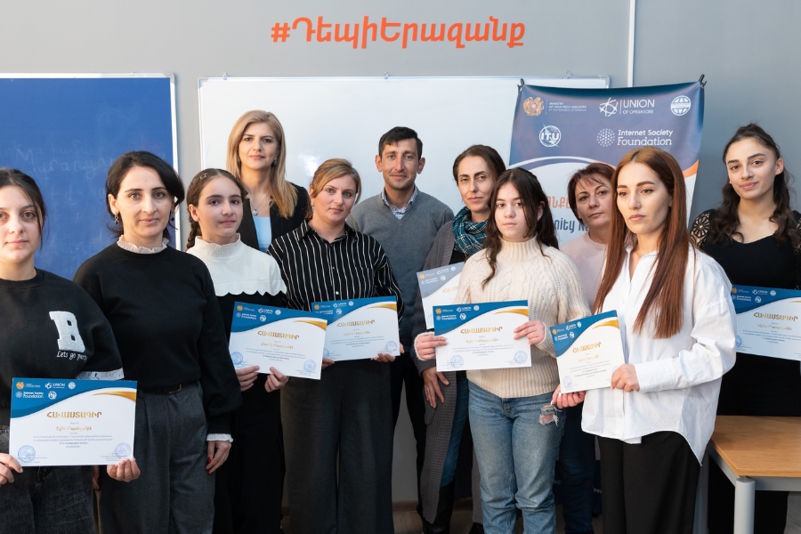 A group of students showing their certificates.