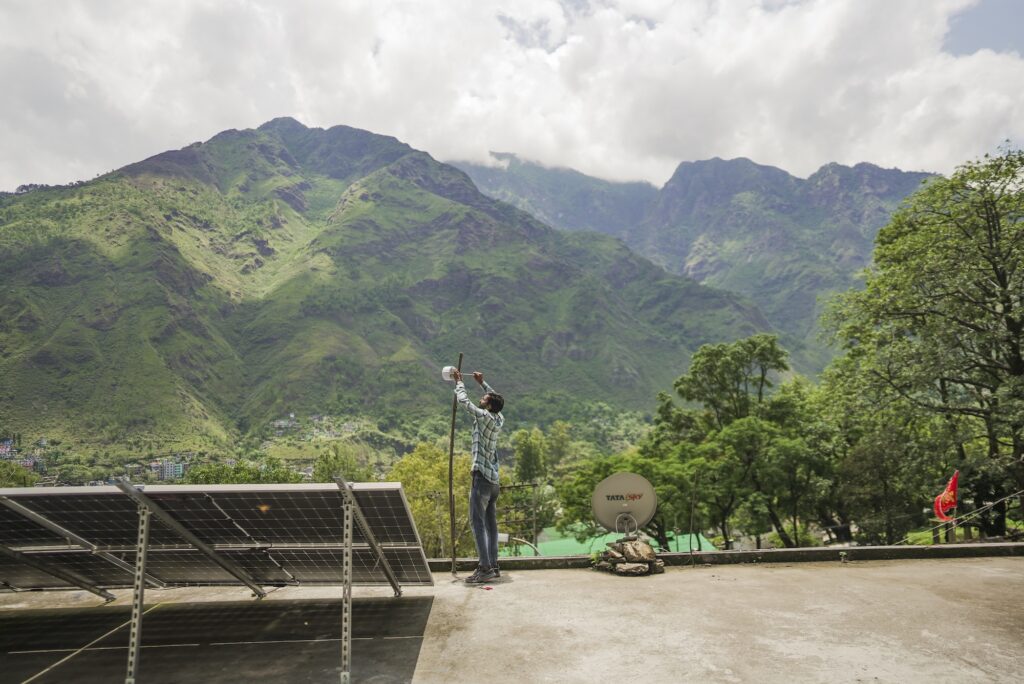 A man assembles an Internet device in a mountain.