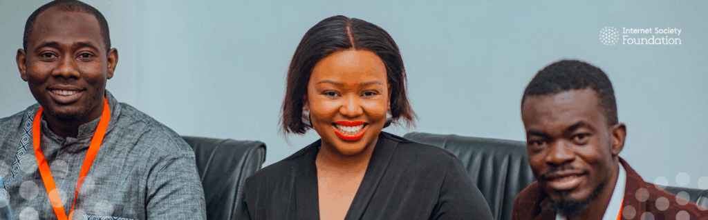 Two african gentlement and african women pose for a photo while attending a school of governance training in Tanzania.