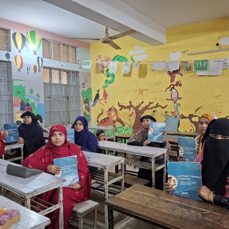 Asia Pacific women seated in a classroom showcasing educational material