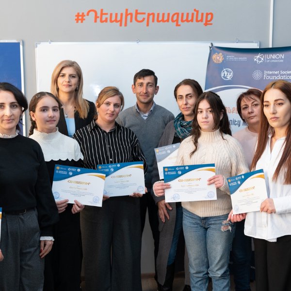 A group of students showing their certificates.