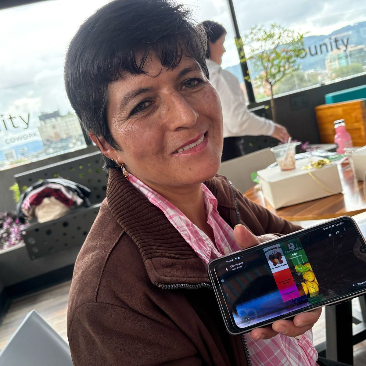 Smiling middle aged woman showcasing an image on the phone