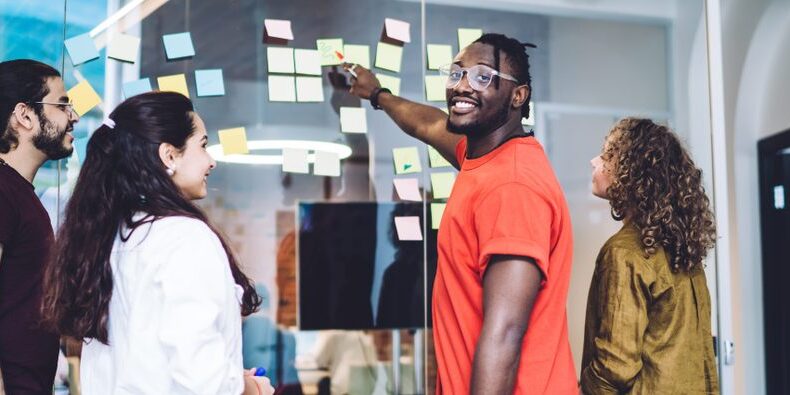 group of people using sticky notes in a meeting