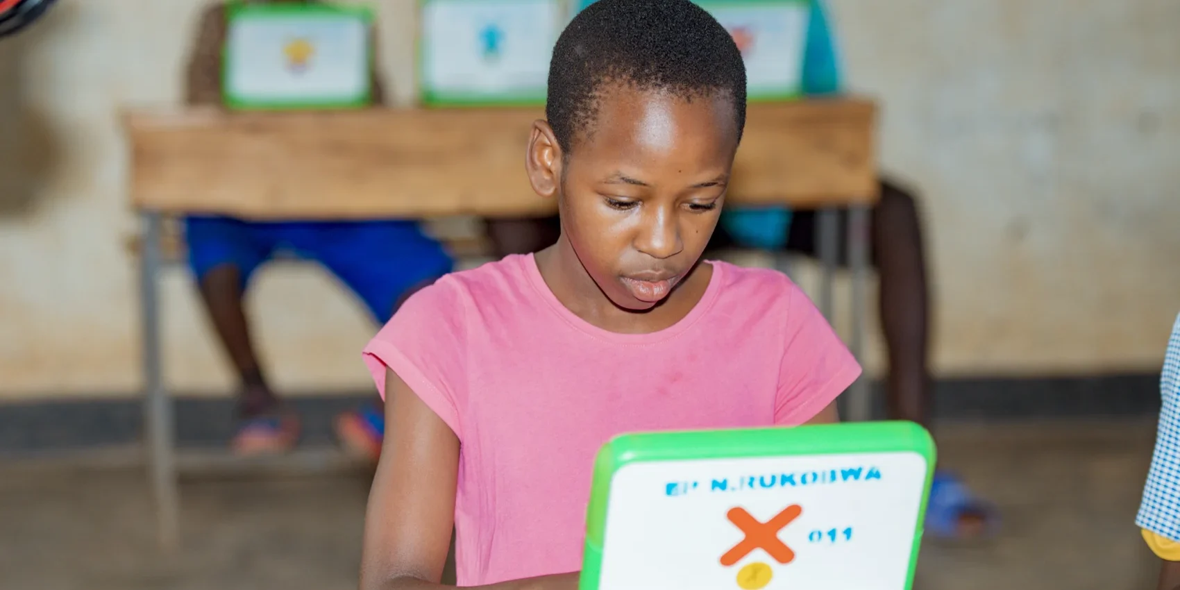 A student works on a OLPC laptop